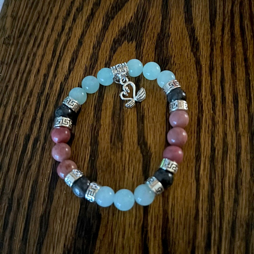 Handmade bracelet with green jade, red jade and tourmaline. Kissing swan charm